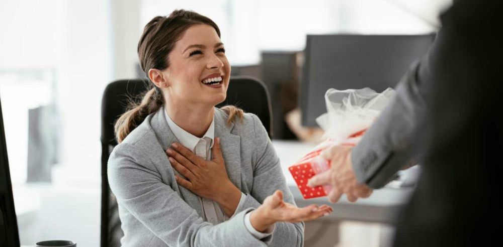 Man giving a gift to his colleague