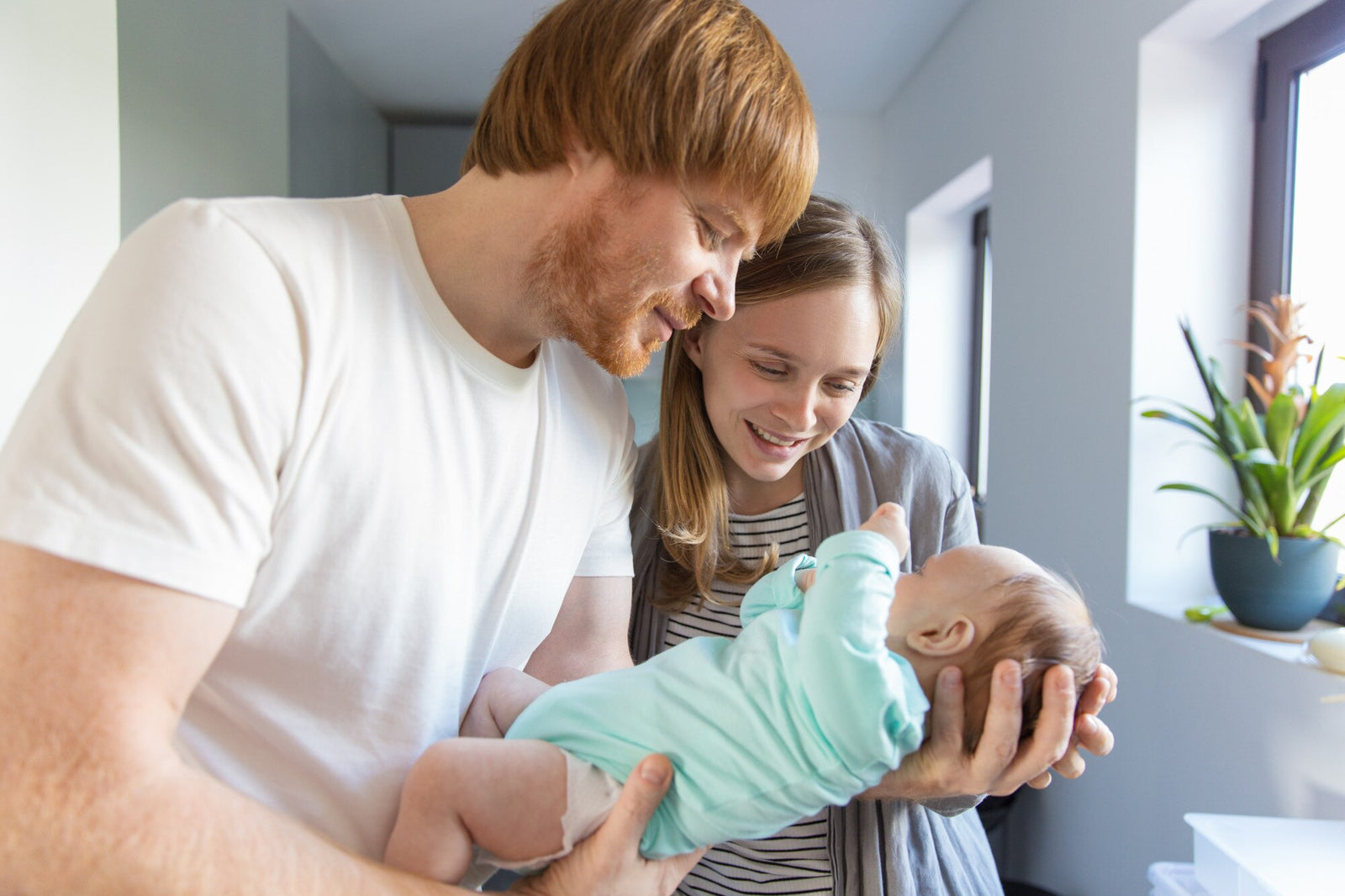 New parents cuddling baby