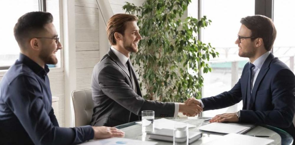 Happy business partners shaking hands